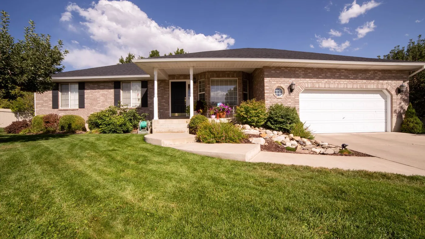 Brick bungalow with attached garage and a level walkway, showing bungalow features downsizers look for in Oro-Medonte