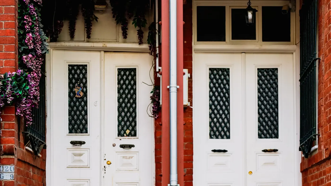 Brick building with two separate front doors side by side, illustrating how to verify a legal duplex in Barrie