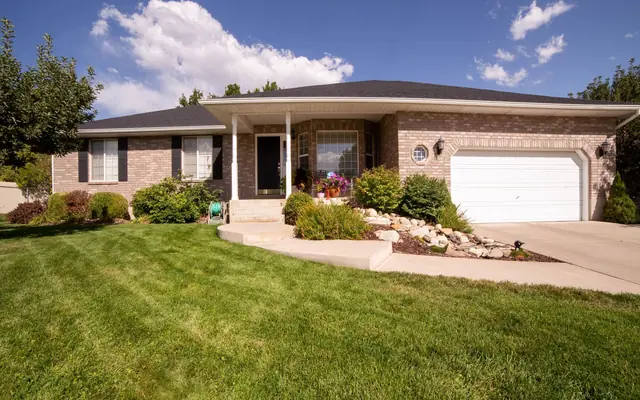 Brick bungalow with attached garage and a level walkway, showing single floor living features in an Oro-Medonte bungalow